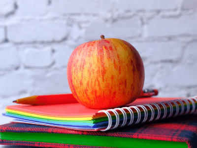 Apple on top of books - back to school