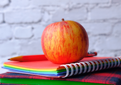 Apple on top of books - back to school